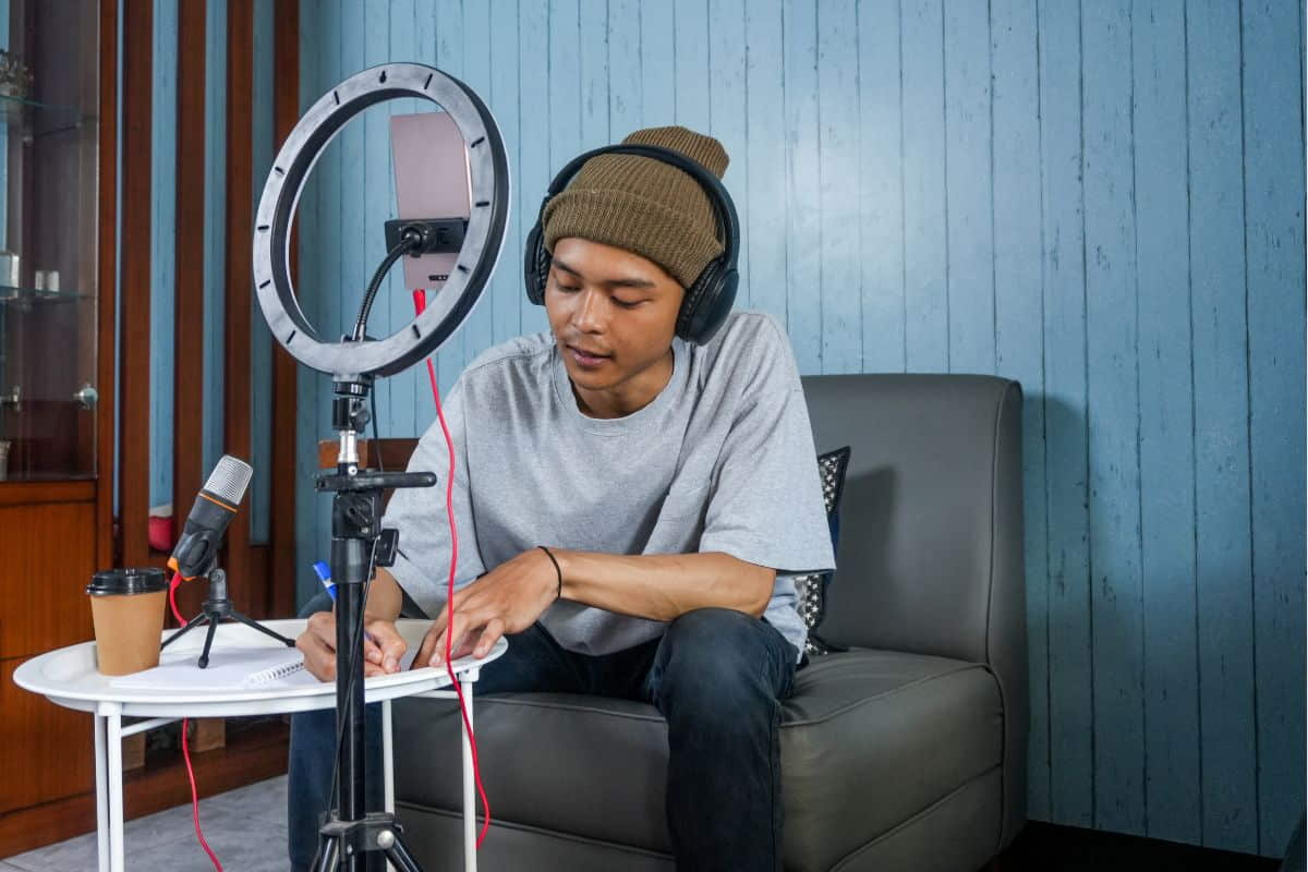 A man sits and writes, planning his audio branding strategy 